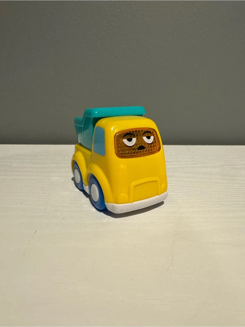 Yellow & Teal Kids Dump Truck Toy - Cute Face Design. Lights up and makes sounds